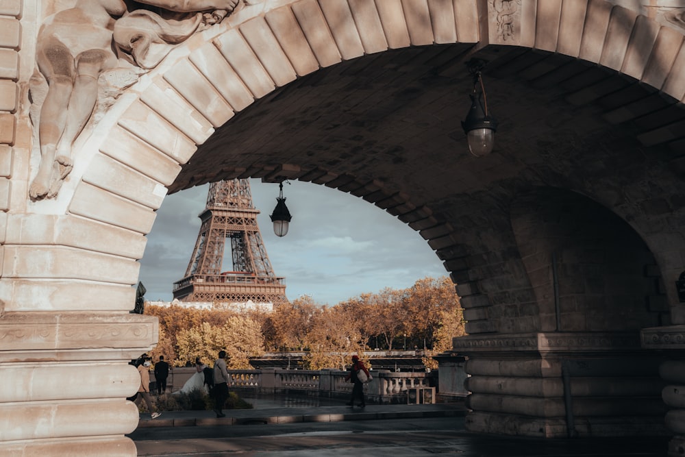 a view of the eiffel tower from under a bridge