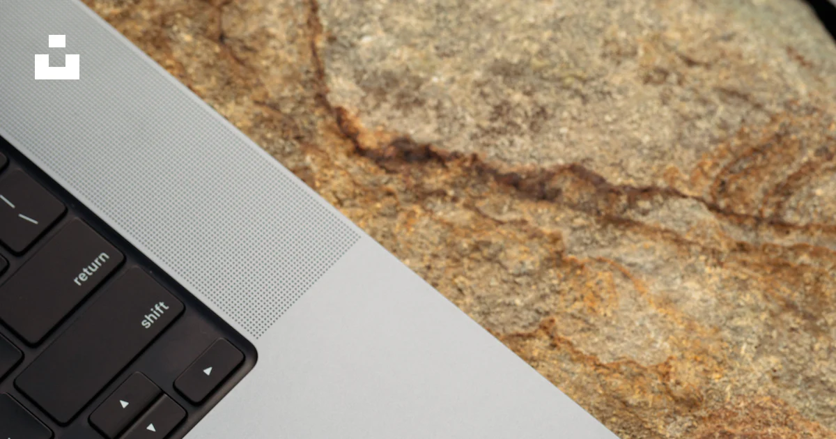A laptop computer sitting on top of a rock photo – Free Computer Image ...