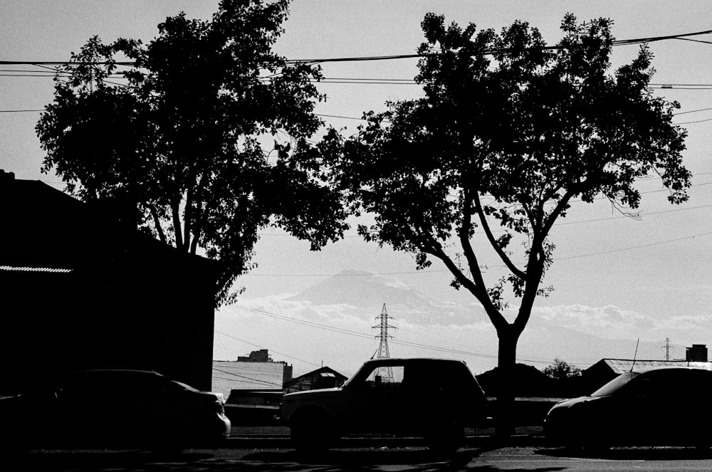 a black and white photo of cars parked in a parking lot