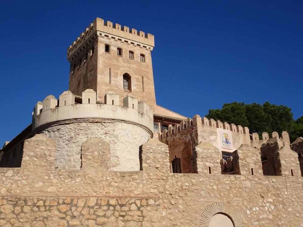 a stone castle with a clock tower on top of it