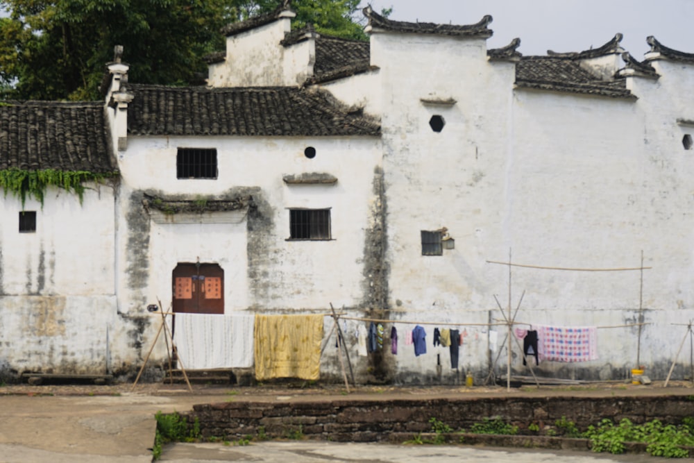 a white building with a bunch of clothes hanging out to dry