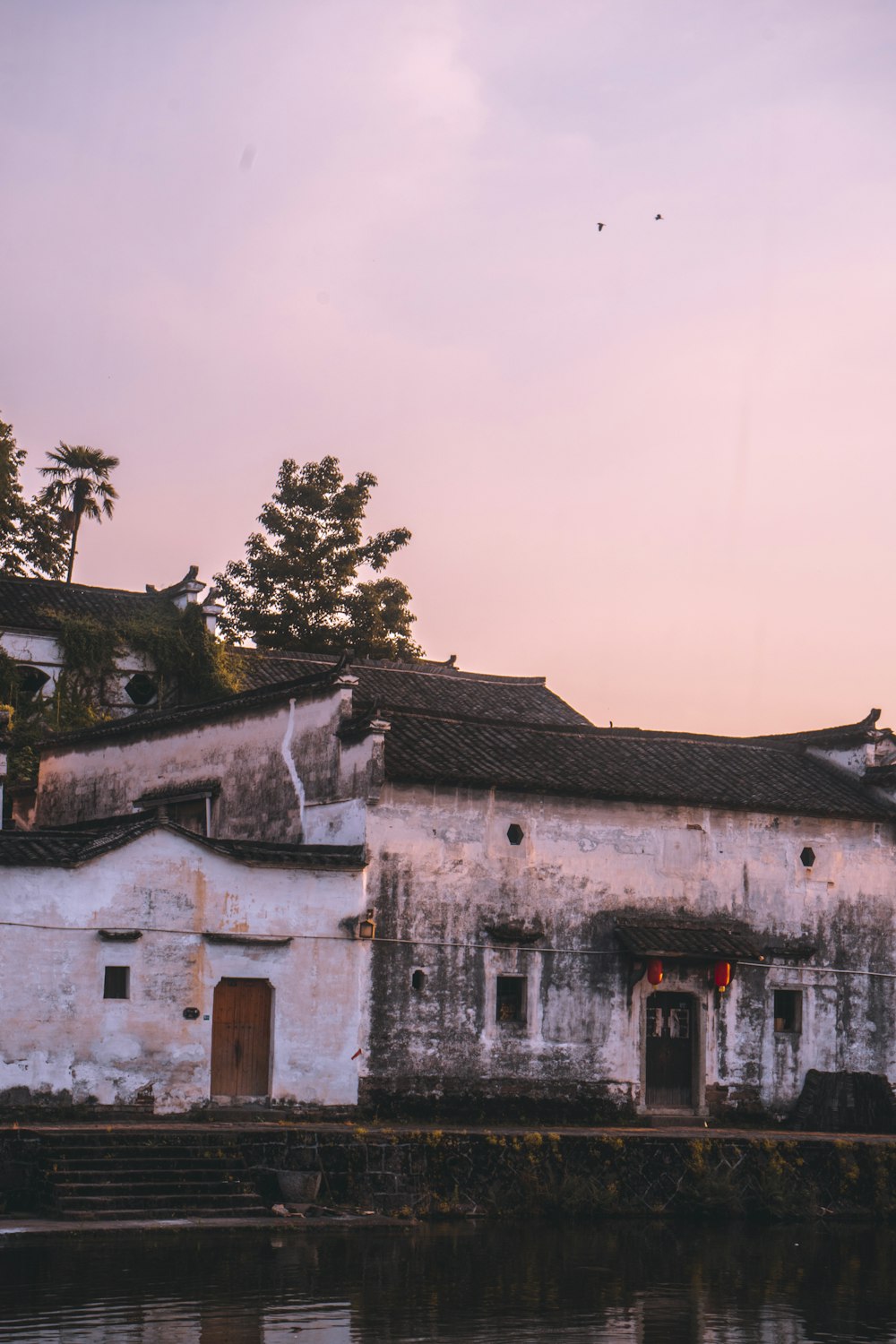 an old building with a water way in front of it