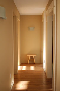 A cozy hallway featuring a natural jute rug runner laid out on warm wooden floors.