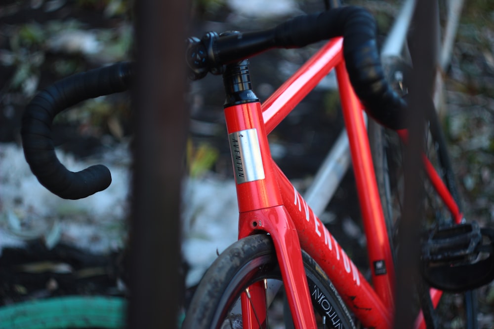a close up of a red bike with a black handlebar