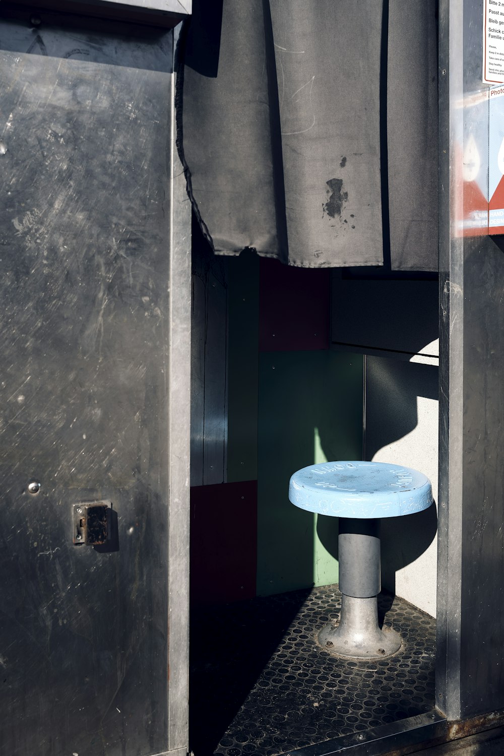 a blue table sitting in the doorway of a building