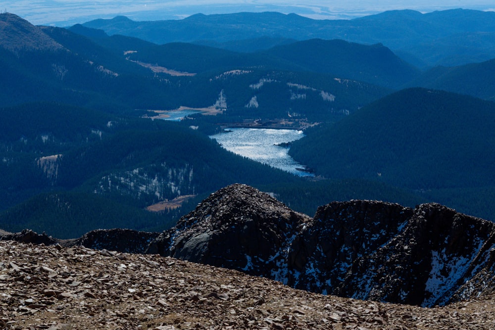 a view of a mountain range with a lake in the distance