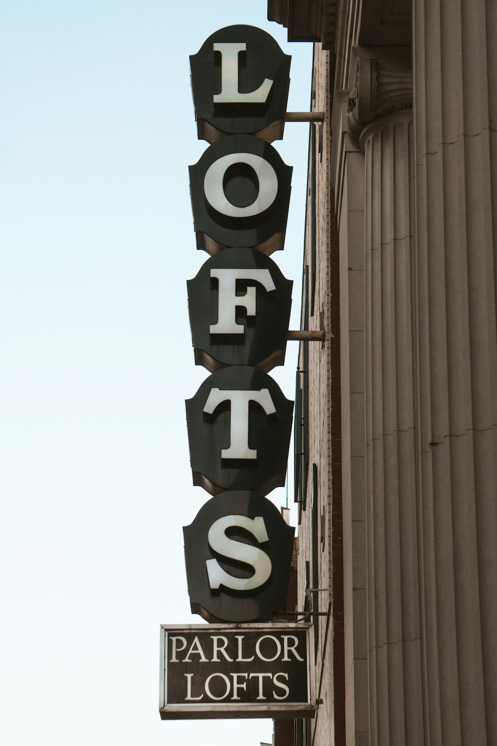 a sign that says lofts on the side of a building