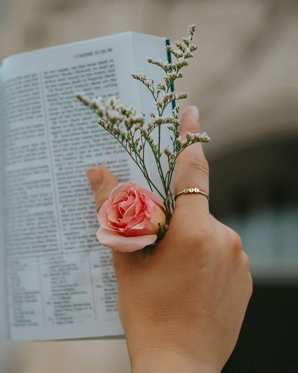 a person holding a book with a flower on it