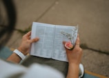 Elegant close-up of hands gently holding a memorial book with handwritten notes