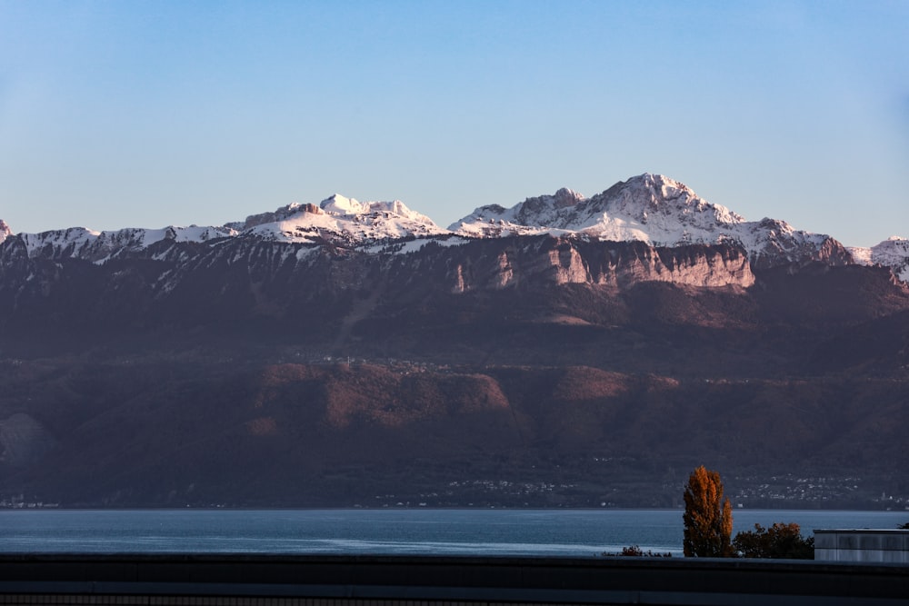 a view of a mountain range with a lake in the foreground