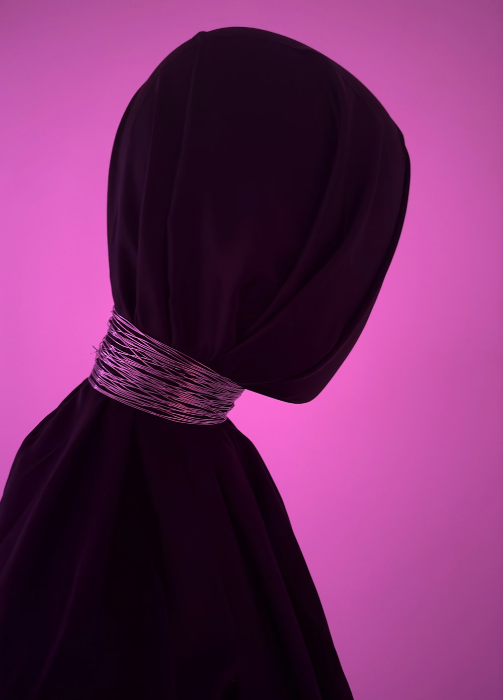 a woman's head covered in a purple cloth