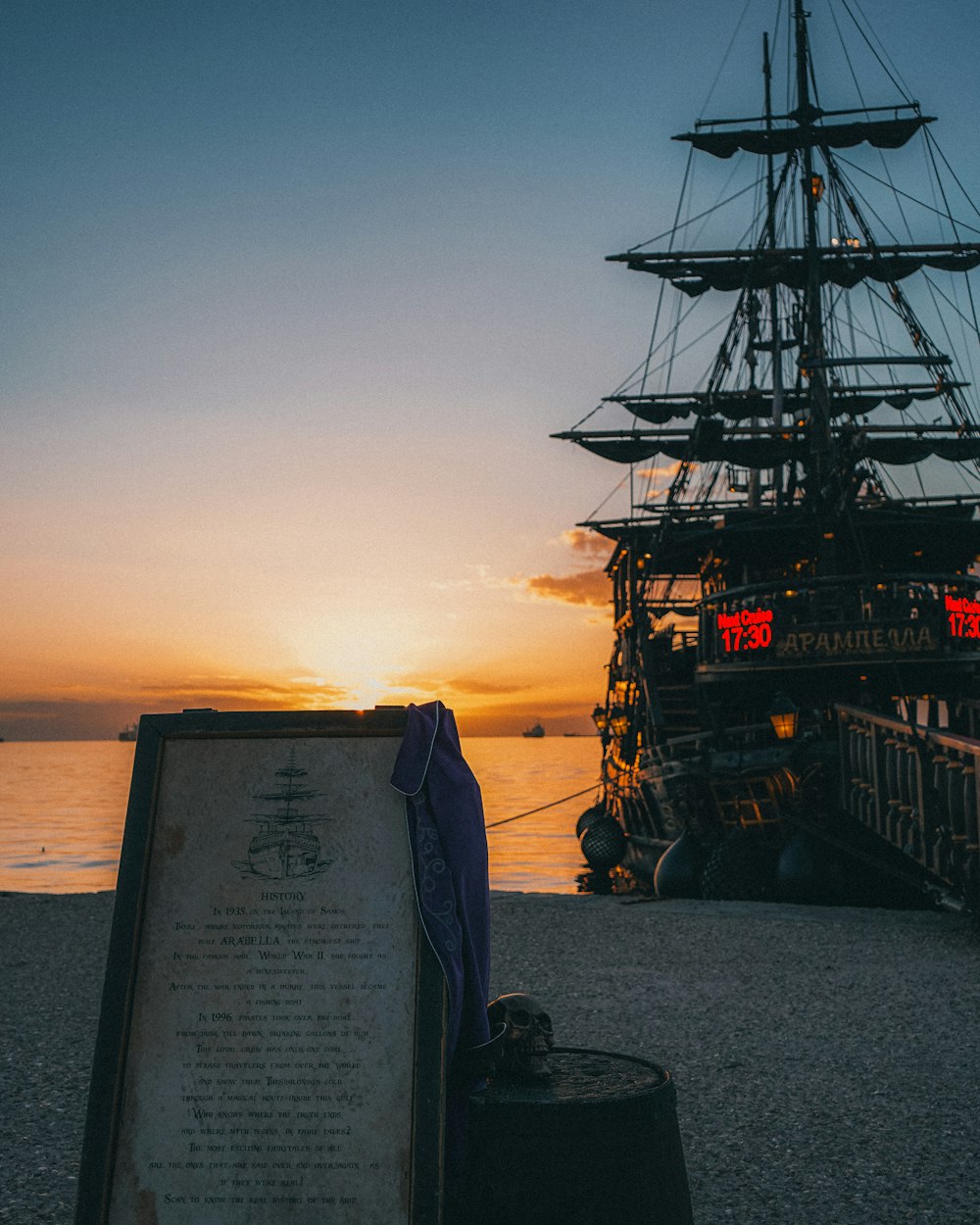 a tall ship sitting on top of a body of water