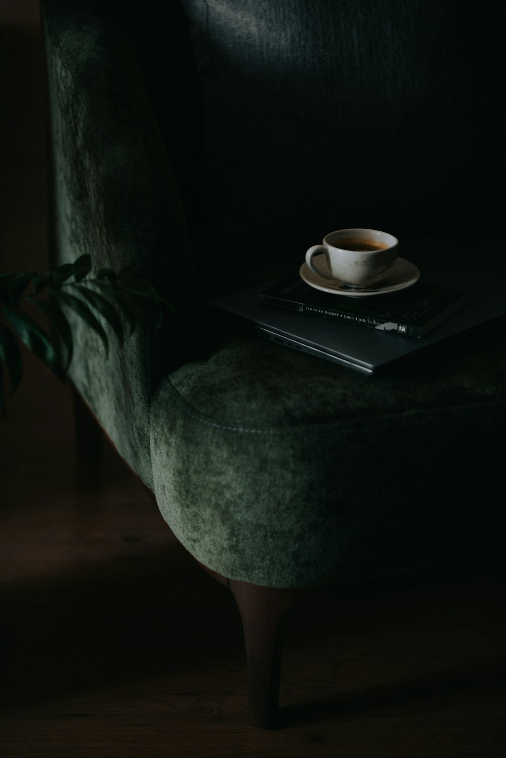 a cup of coffee sitting on top of a green chair