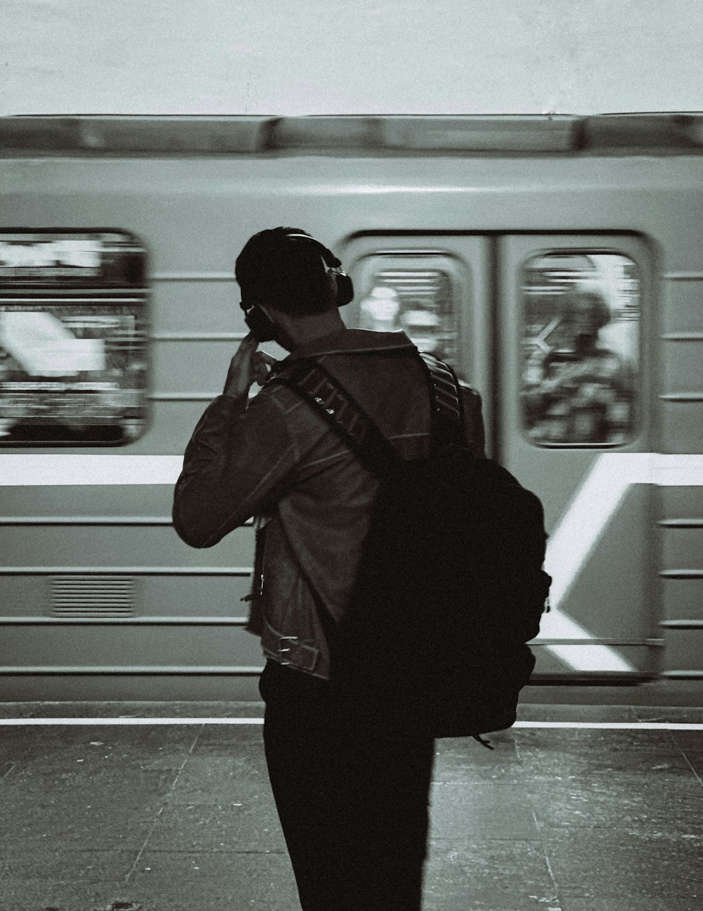 a man with a backpack is on the phone