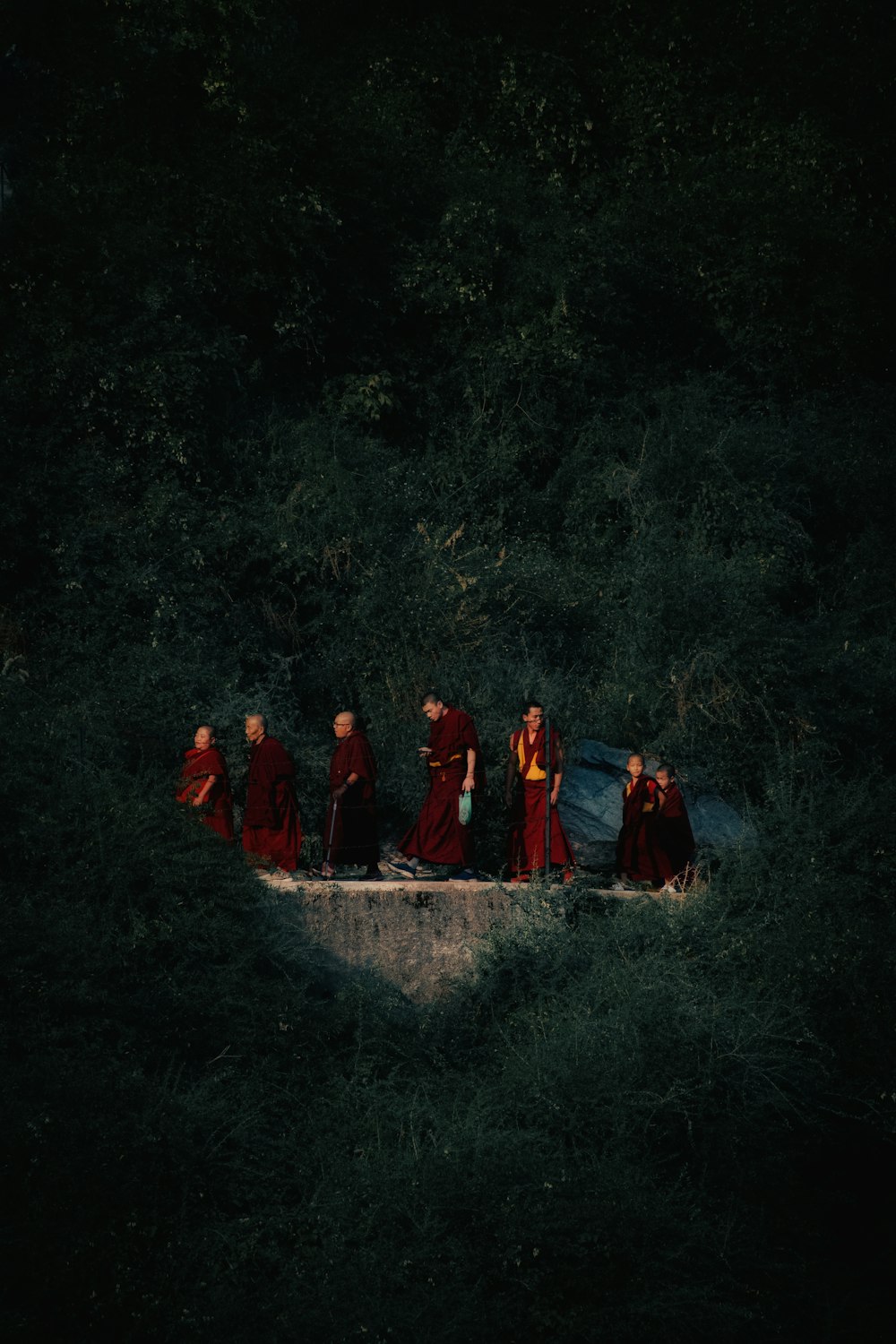 a group of people in red robes standing on a boat