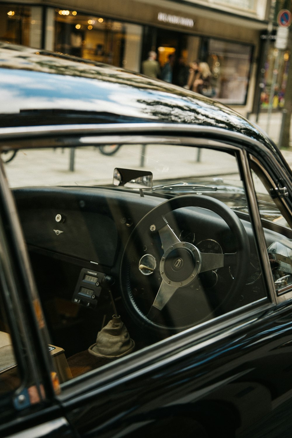 a black car parked on the side of a street