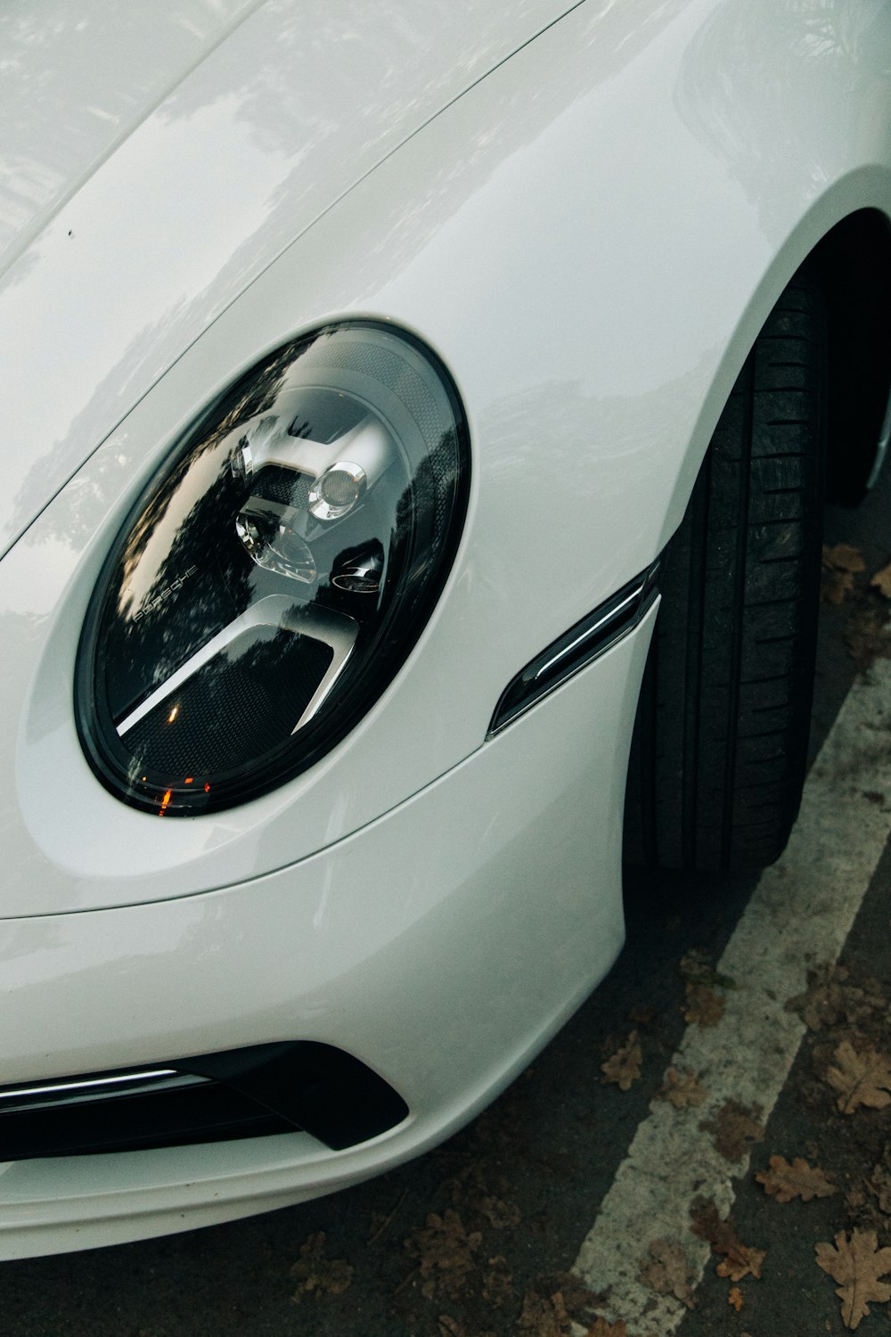 a white sports car parked on the side of the road