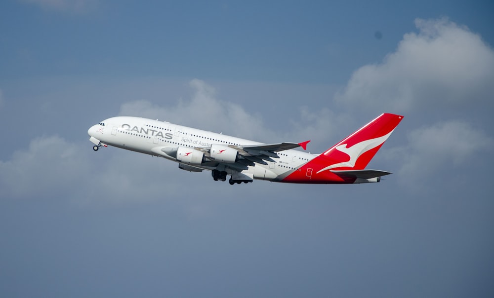 a large passenger jet flying through a cloudy blue sky