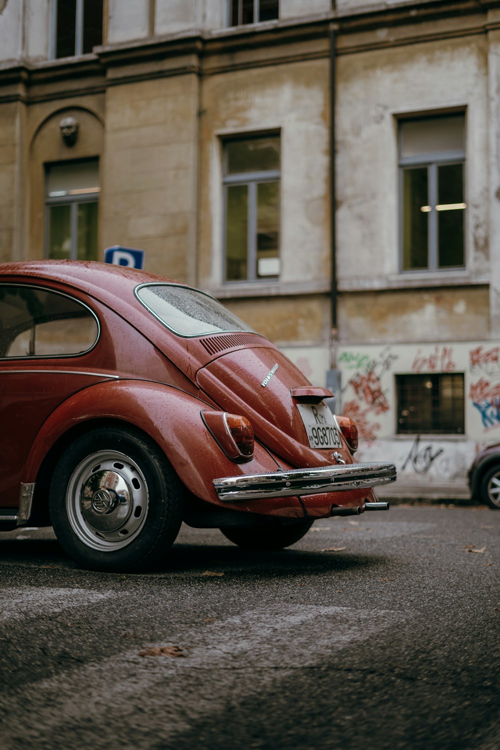 a red car parked in front of a building