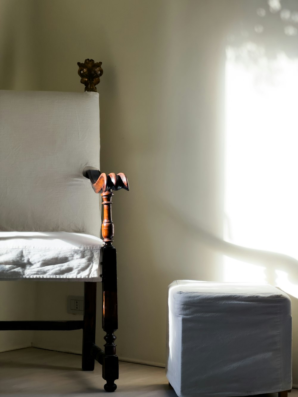 a chair and a foot stool in a room