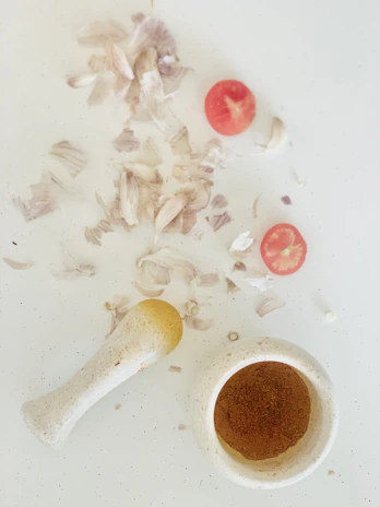 Close-up of organic garlic flour being sifted over a rustic wooden table