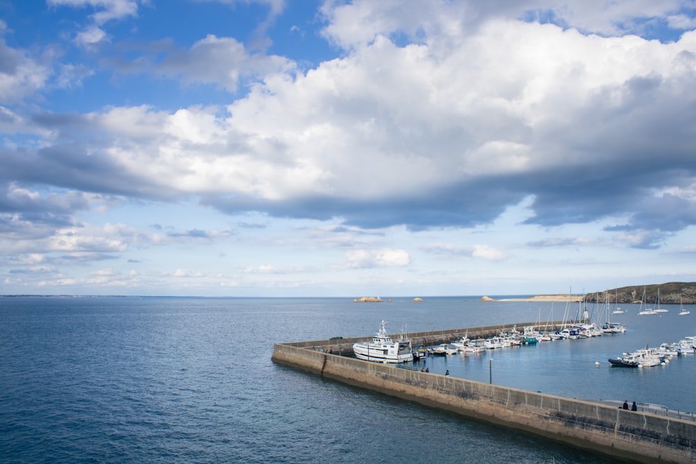 a harbor filled with lots of boats under a cloudy sky