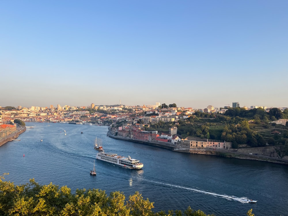 a large boat traveling down a river next to a city