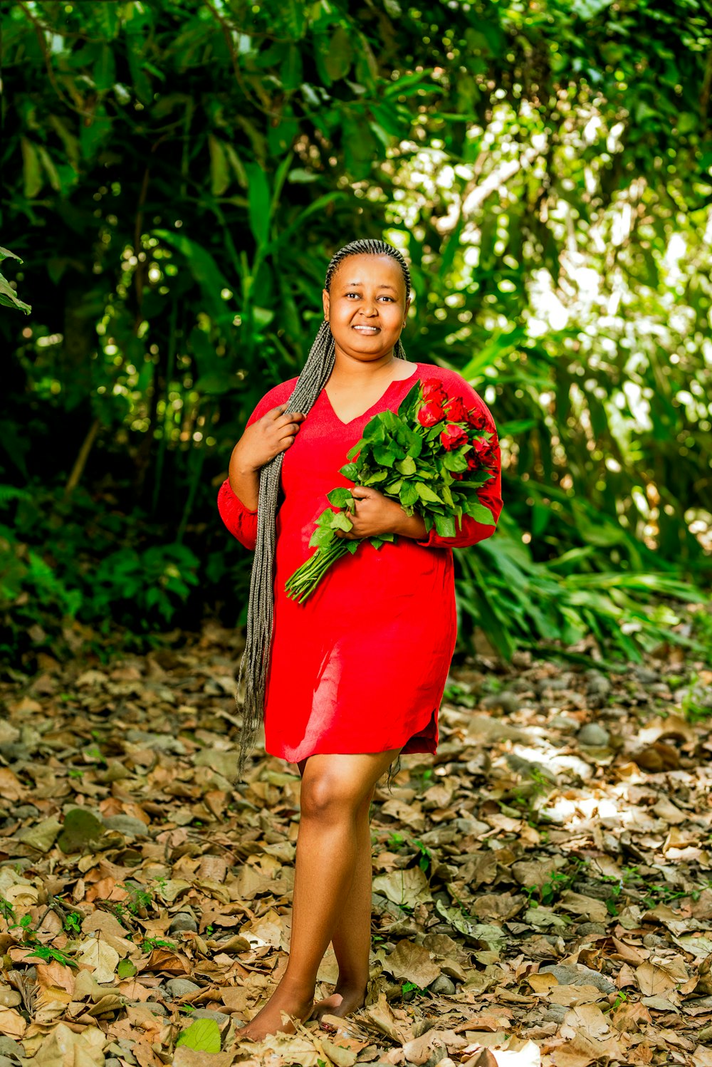 a woman in a red dress holding a bouquet of flowers