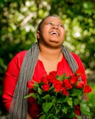 A joyful client showing off her new braided hairstyle outdoors