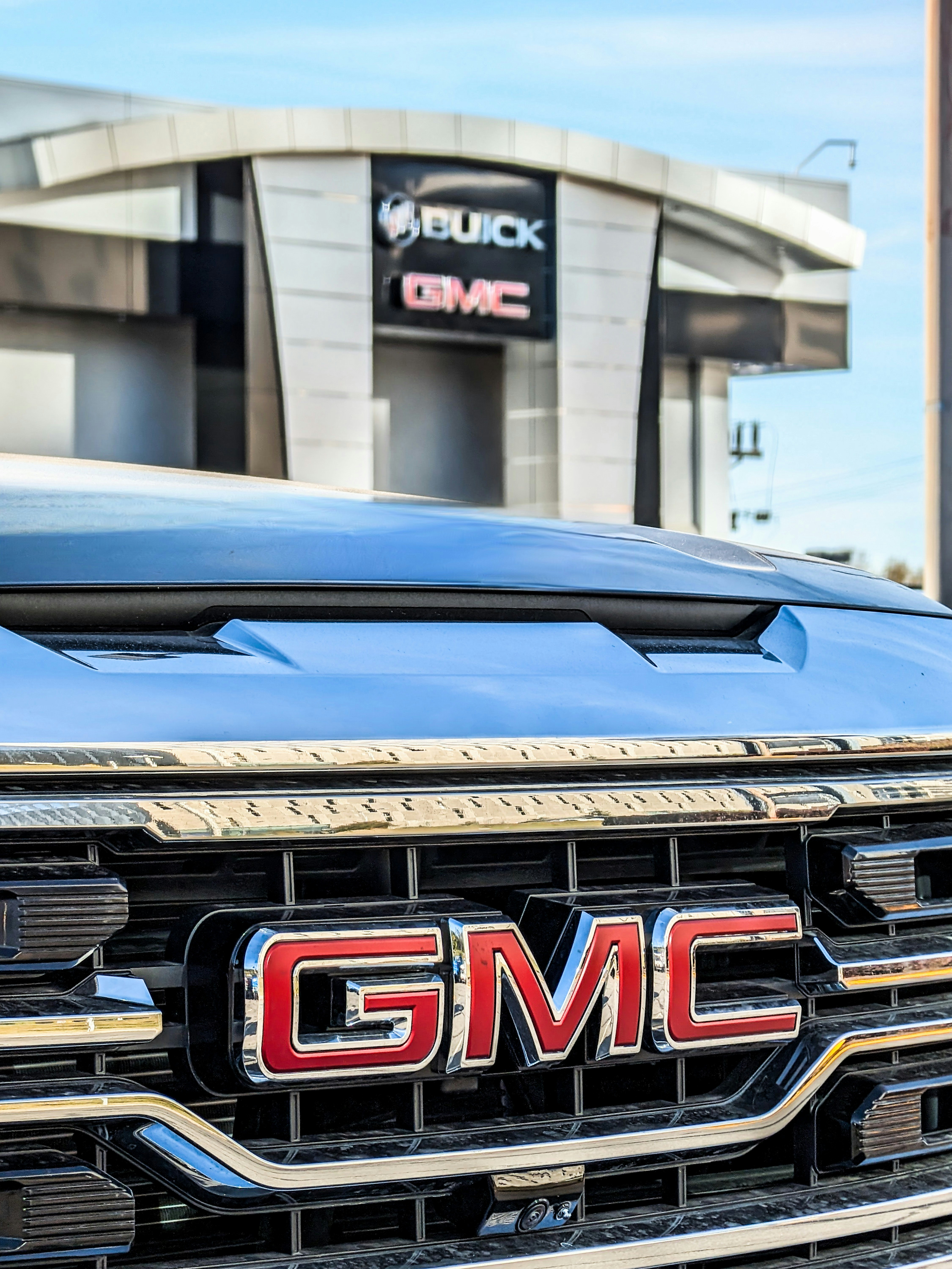 a close up of the grille of a gmc truck