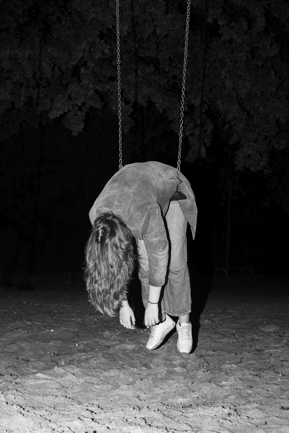 a person on a swing in the dark