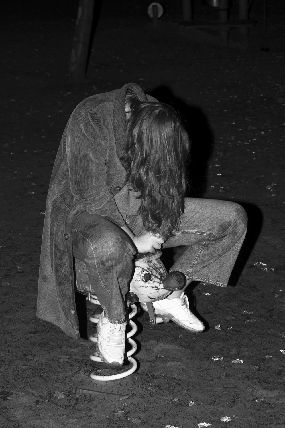 a man sitting on top of a skateboard on the ground