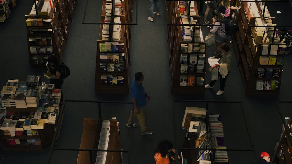 a group of people standing in a library filled with books