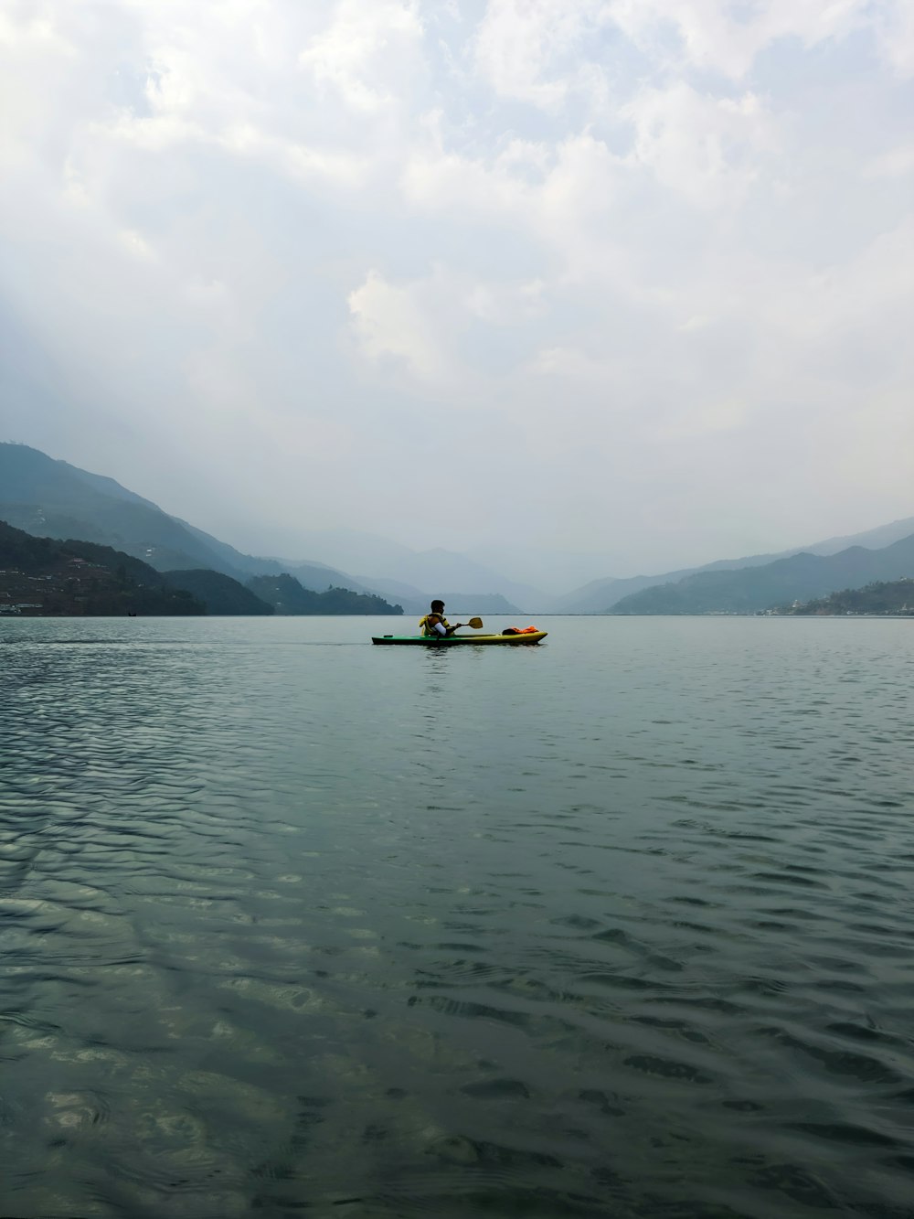 two people in a canoe on a lake