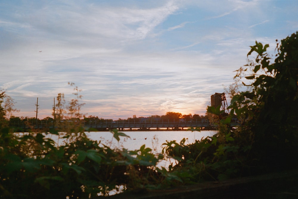 the sun is setting over a body of water