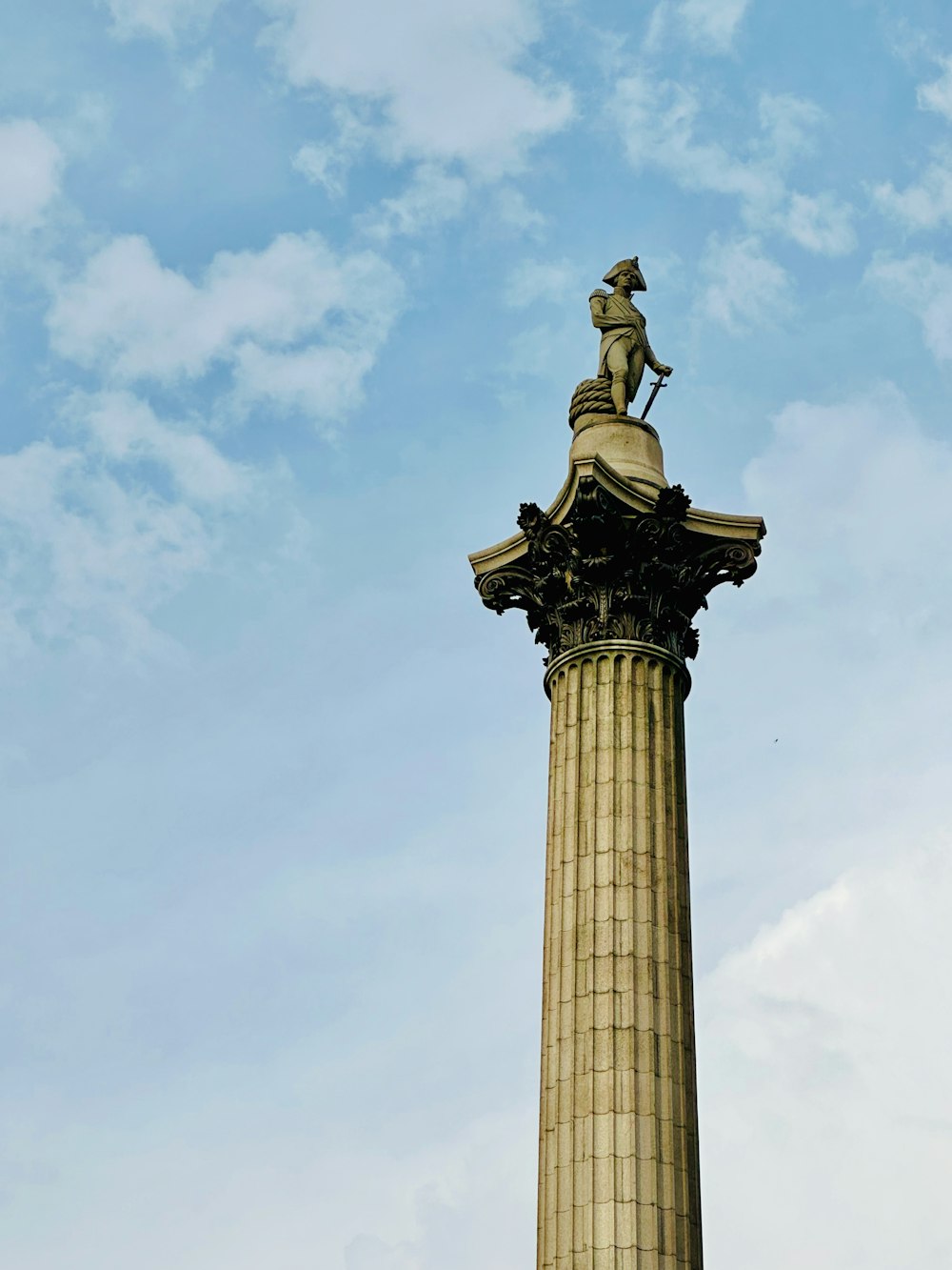 a statue of a man on top of a pillar
