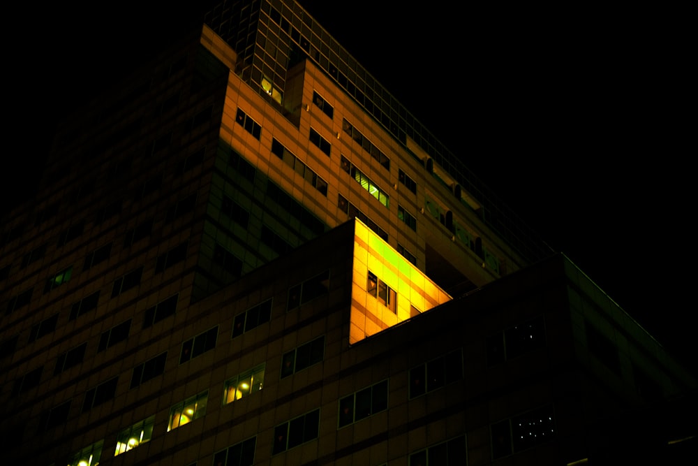 a tall building lit up at night time