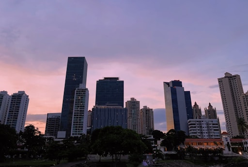 A modern Istanbul skyline at sunset with residential and commercial buildings.