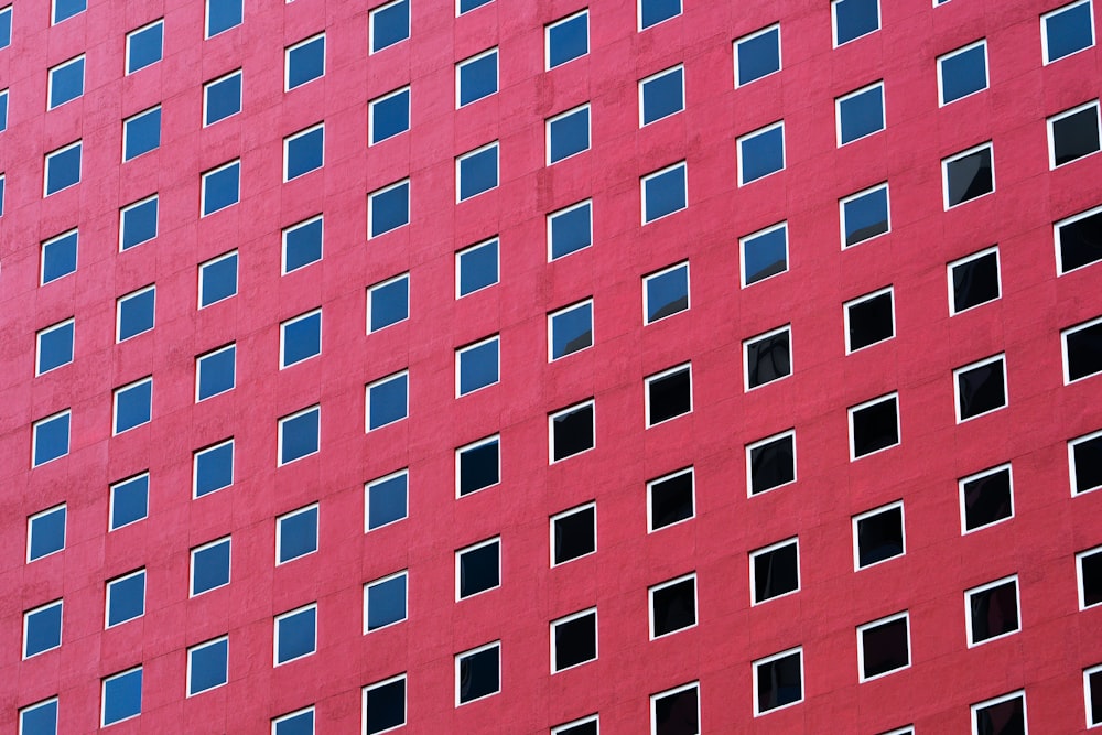 a red building with many windows and a clock