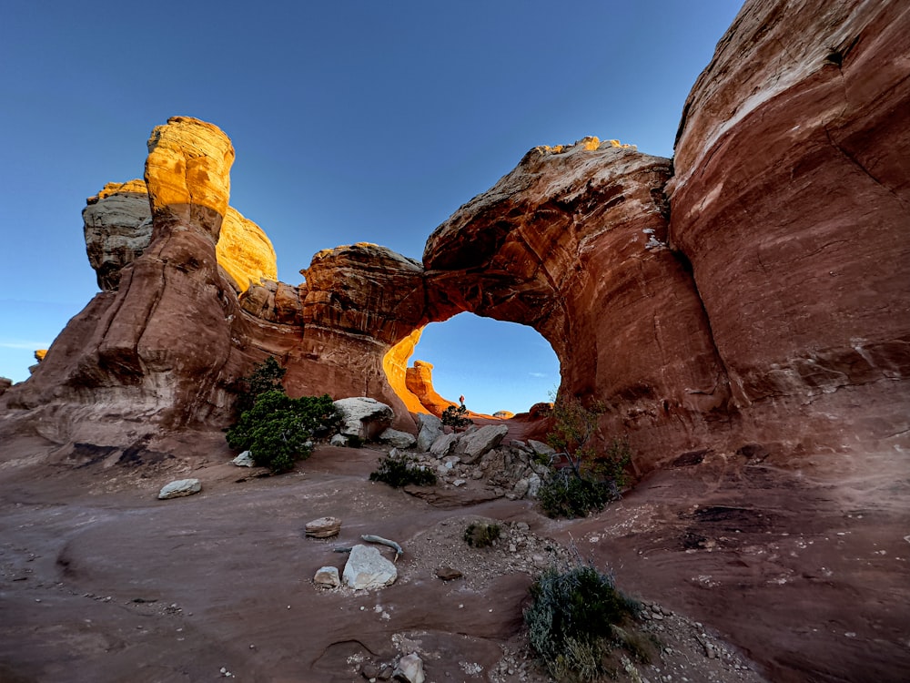 a rock formation in the desert with a blue sky in the background