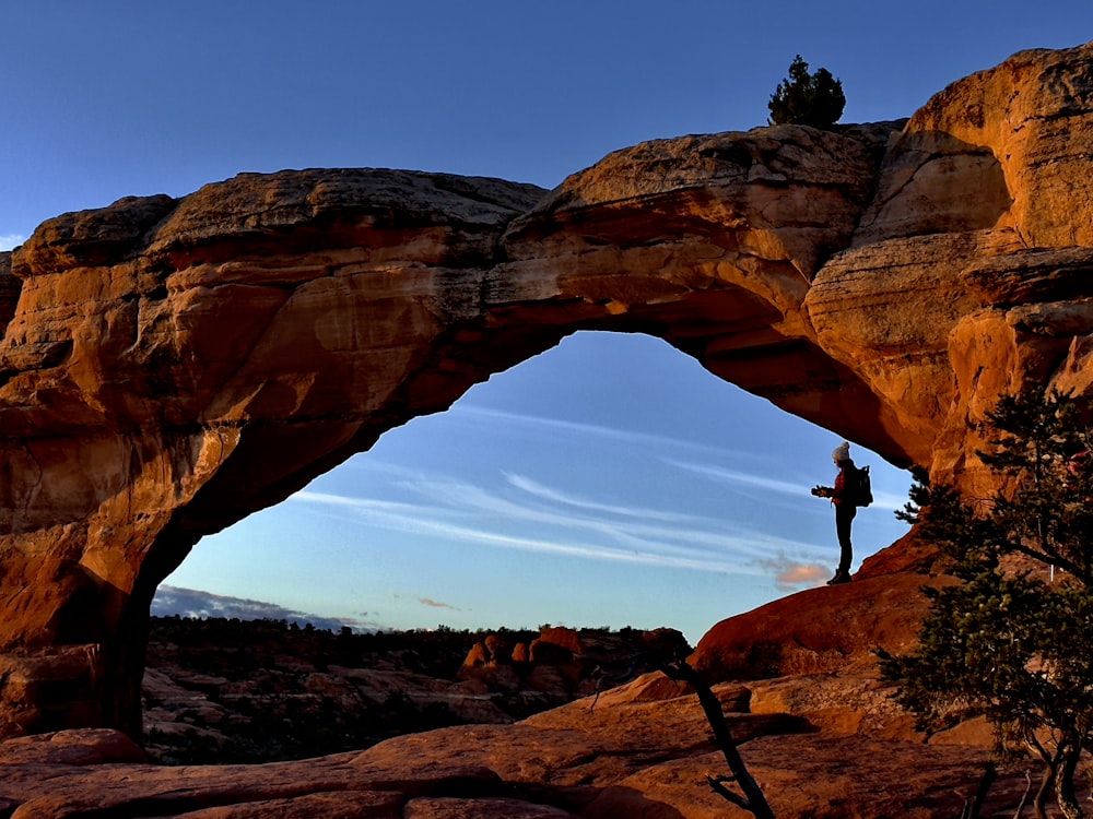 a person standing on top of a rock formation