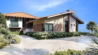 A modern house with a red-tiled roof and beige walls is situated in a landscaped setting. The driveway features neatly trimmed greenery and a parked white car. The blue sky and distant mountains create an inviting and serene ambiance.
