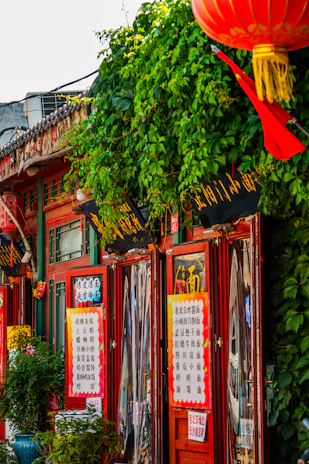 A vibrant storefront of muanhanh bustling with customers and colorful promotional banners.