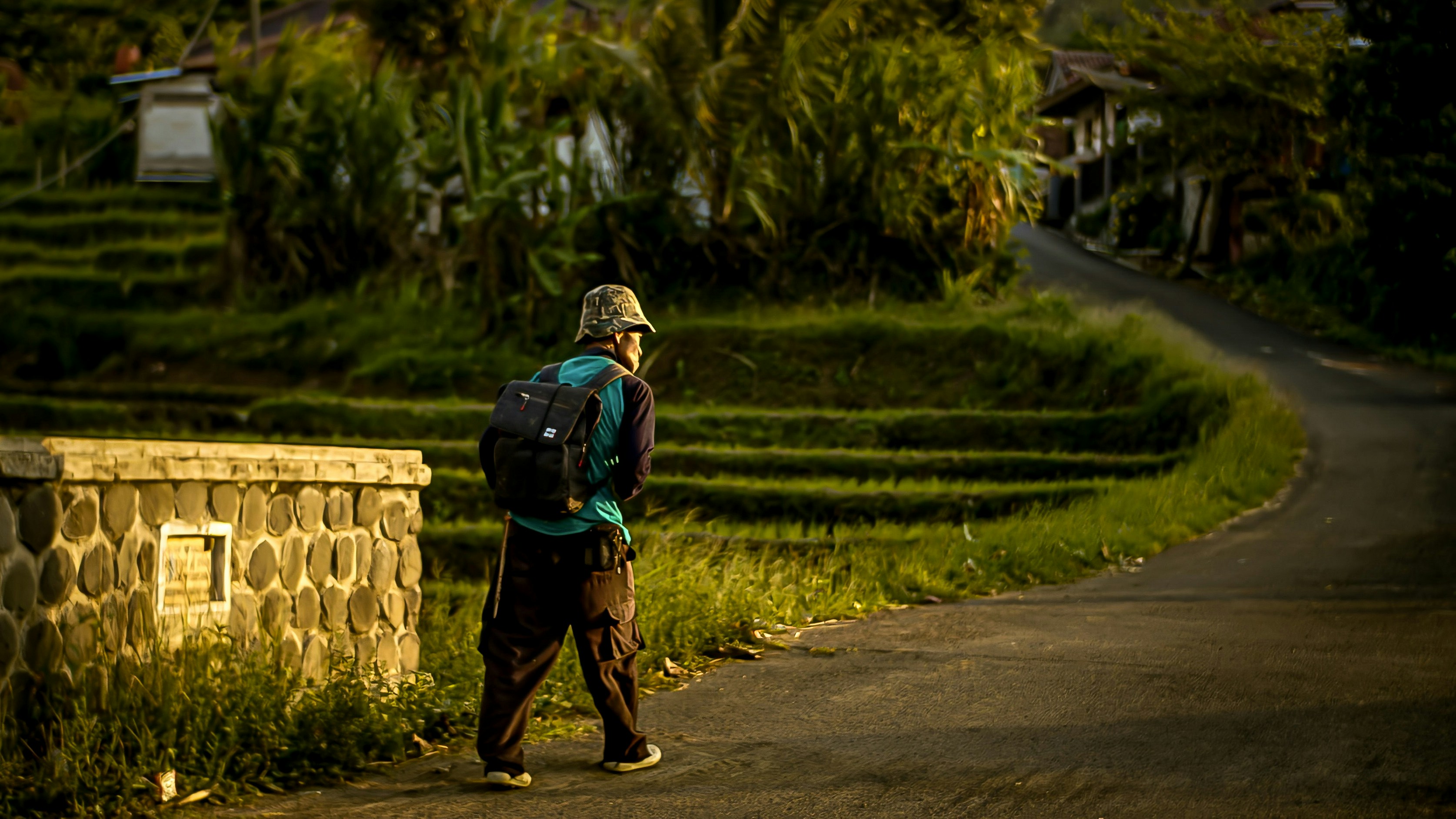 a person with a backpack walking down a road