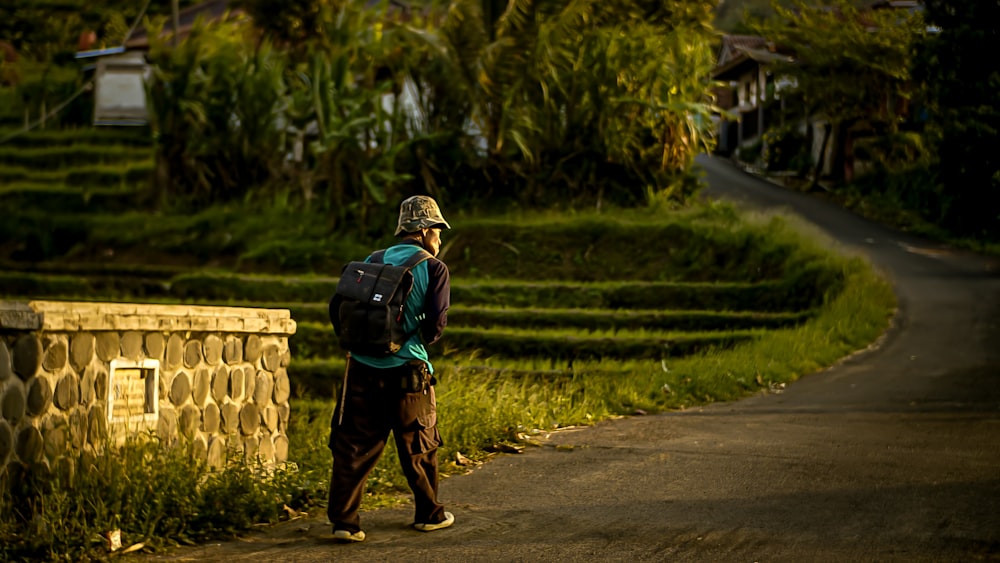 a person with a backpack walking down a road