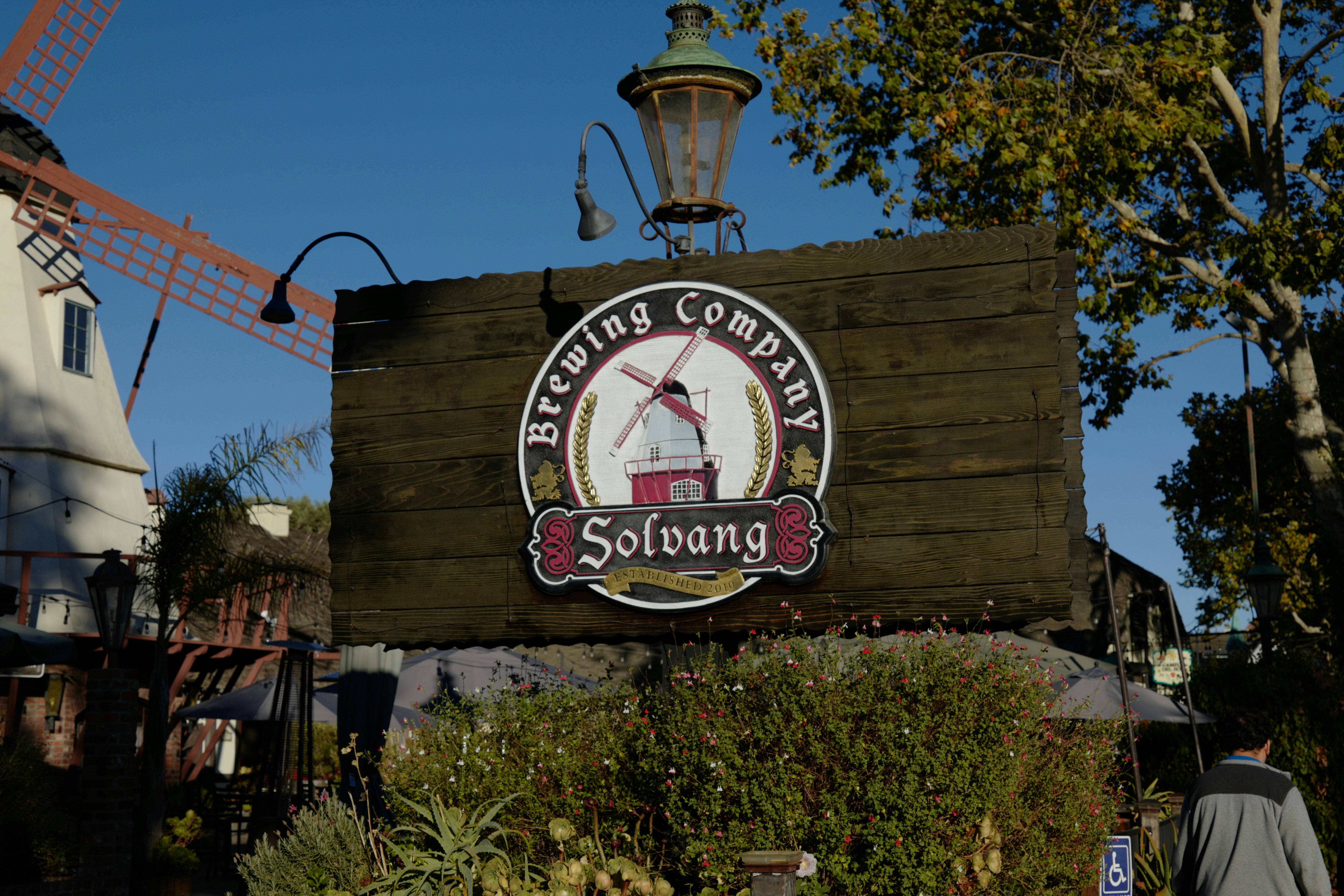 a sign for a restaurant with a windmill in the background