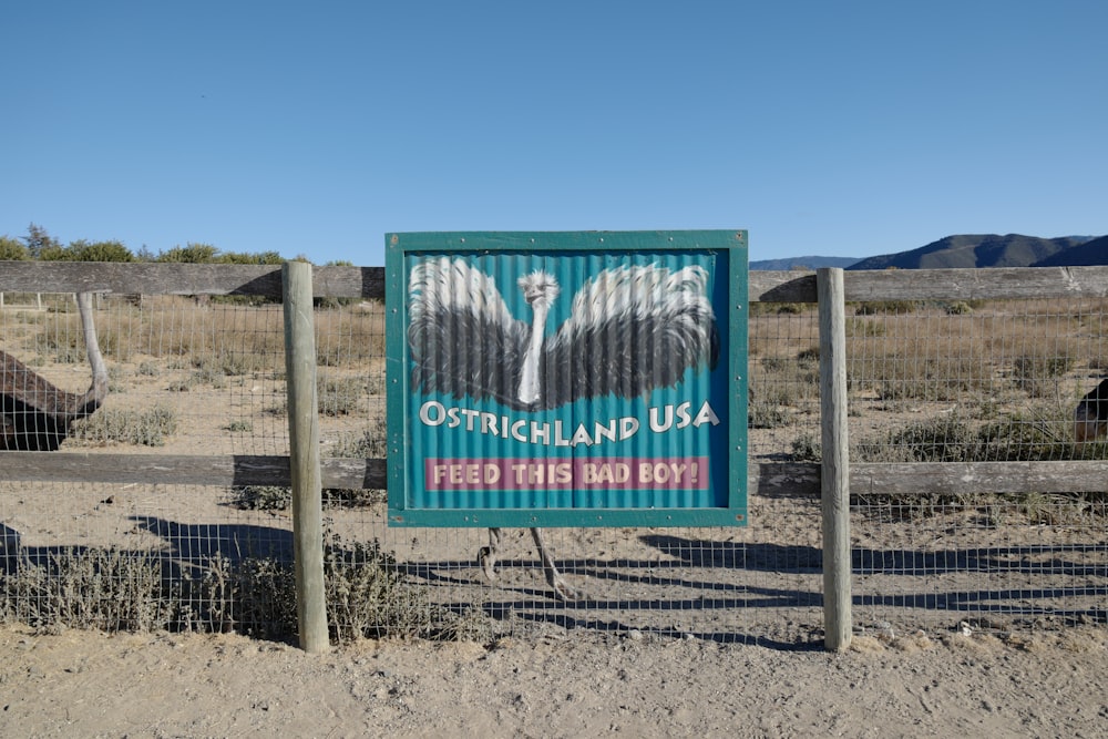 a sign in the middle of a dirt field