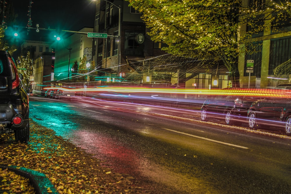 a car driving down a city street at night