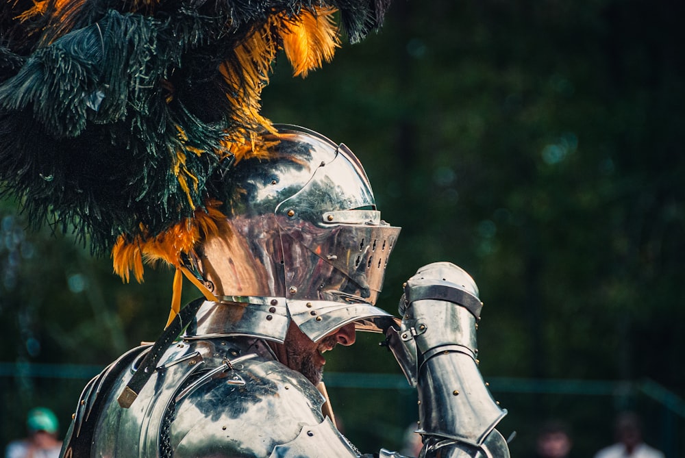 a close up of a knight's armor with feathers on it