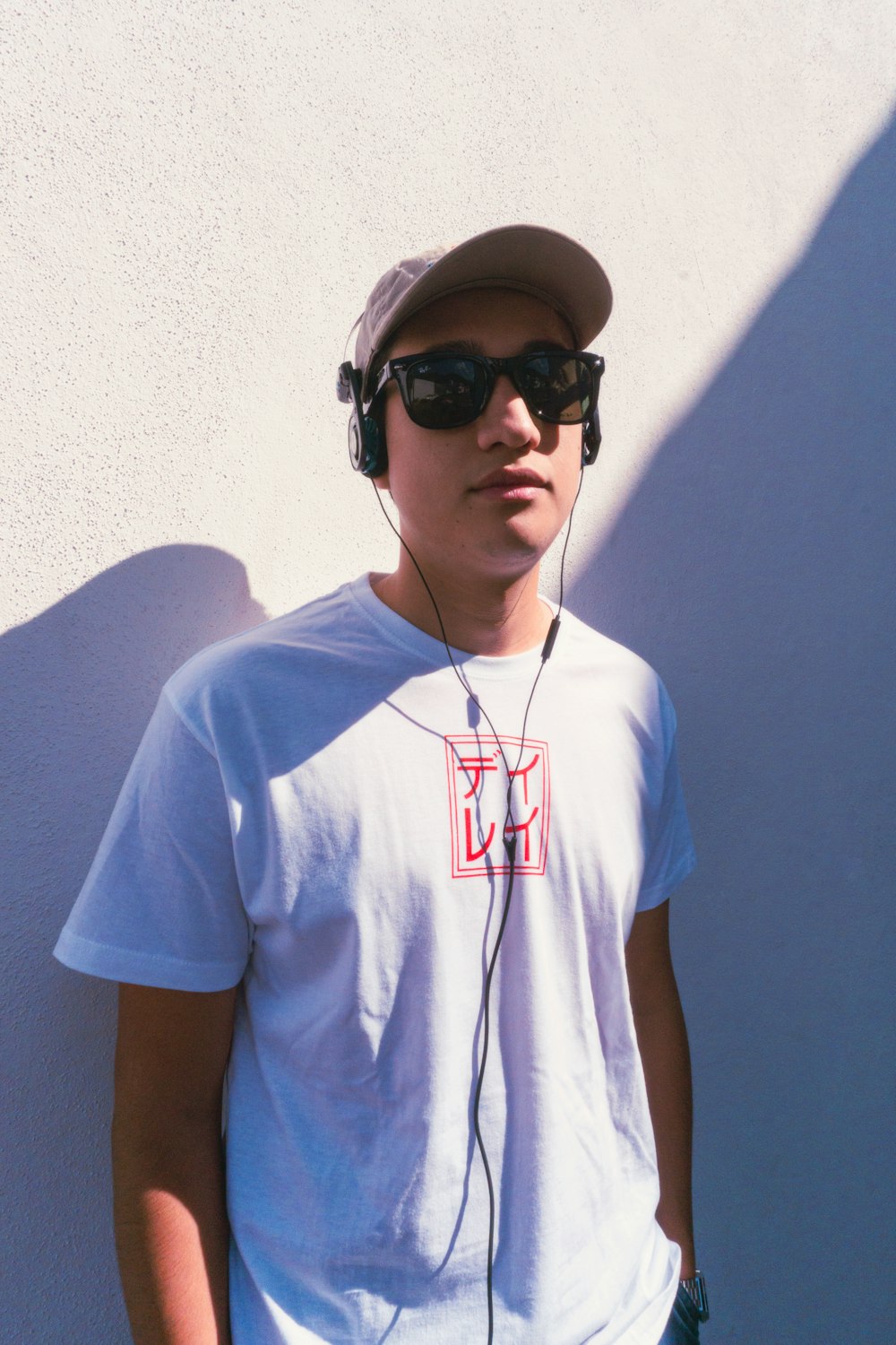 a young man wearing headphones and a hat